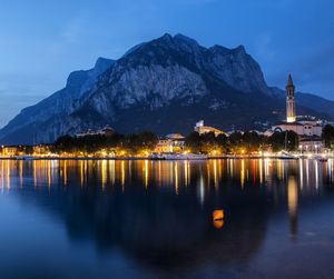 Scenic view of lake with light reflection against mountains