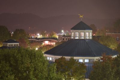 Illuminated building against sky at night