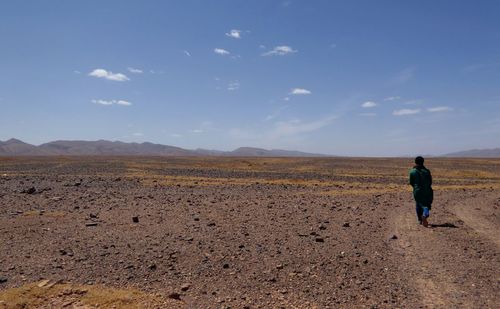 Man standing on desert against sky