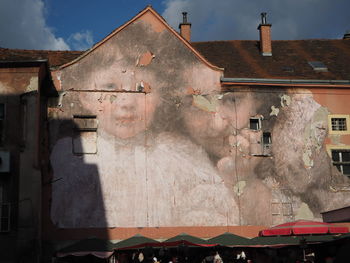 Exterior of old building in town against sky