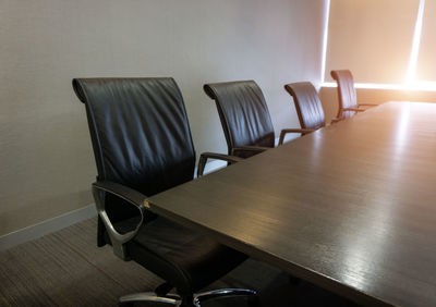 Empty chairs in conference room at office