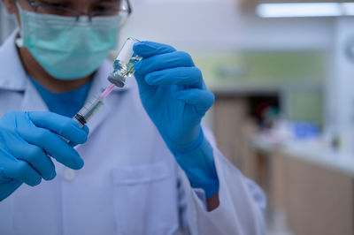 Midsection of person holding umbrella