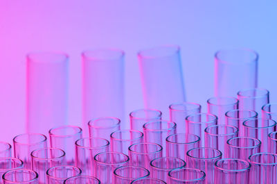 Close-up of test tubes against colored background