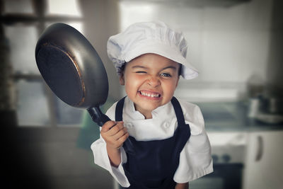 Portrait of young girl in chef's outfit