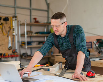 Side view of man working at office