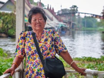 Mid adult woman standing by lake