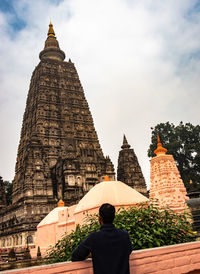 Rear view of man standing against temple