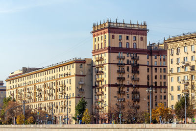 Buildings in city against clear sky