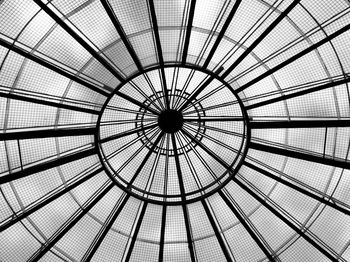 Low angle view of skylight by geometric ceiling in glass material 