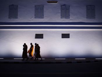 Group of people walking in front of building