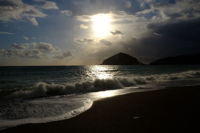 View of beach against cloudy sky