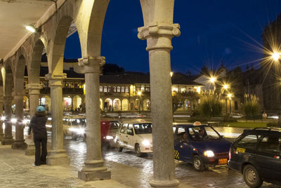 Cars moving on illuminated street at night