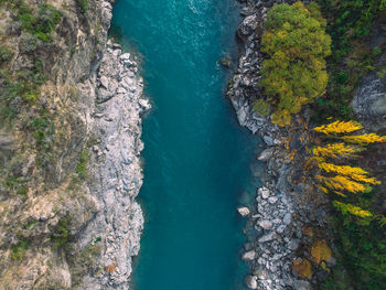 High angle view of river amidst cliff and forest