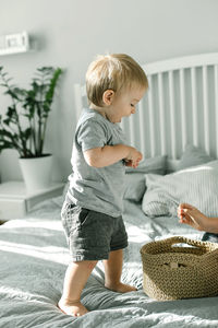 Baby playing with wooden toy. kids hands holding a wooden blocks. eco friendly, zero waste concept.