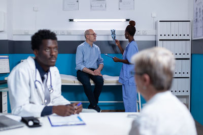 Doctors examining patients in clinic