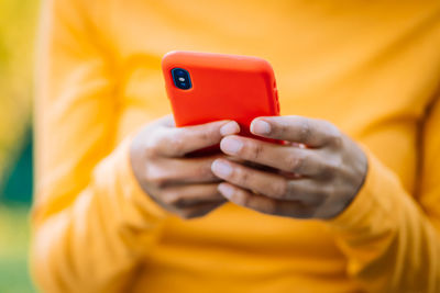 Midsection of man using mobile phone