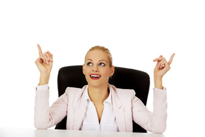 Portrait of young woman against white background