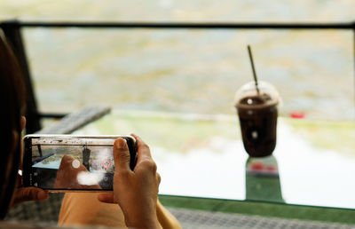 Close-up of person photographing with mobile phone