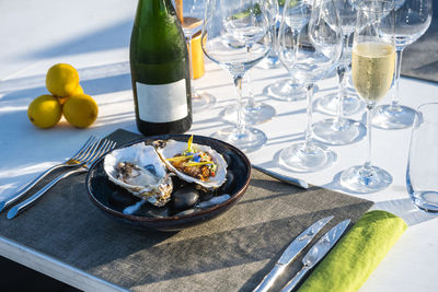 Delicious and well decorated oyster's dish paired with champagne at outdoor high cuisine restaurant