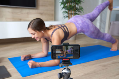 Woman recording herself while working out