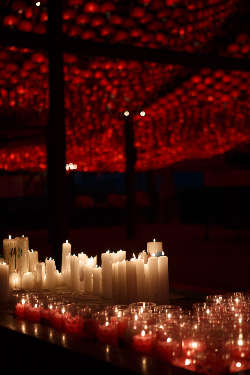 ILLUMINATED CANDLES AGAINST BUILDING