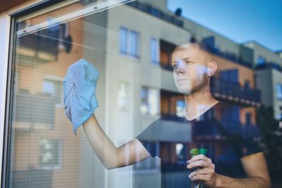 Man cleaning window glass