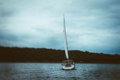 Sailboat in sea against sky