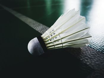 Close-up of shuttlecock on badminton court