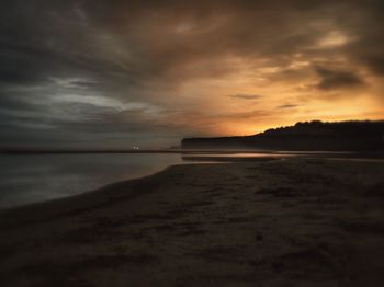 Scenic view of sea against cloudy sky