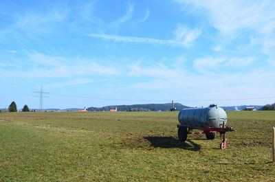 View of horse cart on field against sky