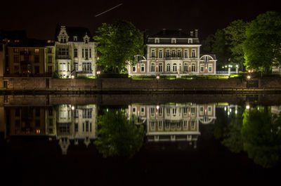 Reflection of building in water at night