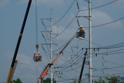 Low angle view of electricity pylon against sky