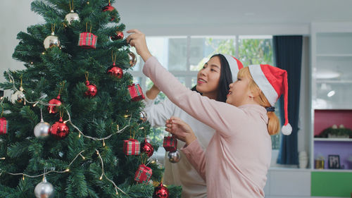 Woman with christmas tree at home