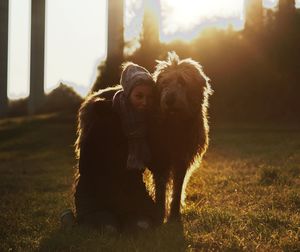 Woman with irish wolfhound on field against sky