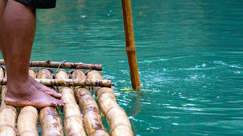 Punting down a river on a bamboo raft