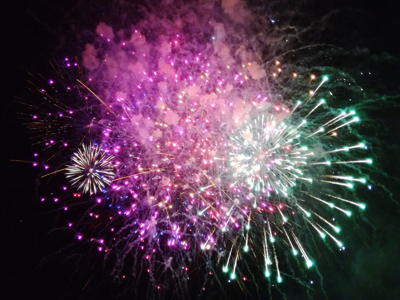 LOW ANGLE VIEW OF FIREWORK DISPLAY IN SKY AT NIGHT