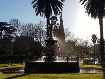 Fountain in park against clear sky