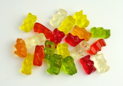 Close-up of multi colored candies against white background