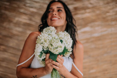 Portrait of woman holding flower bouquet