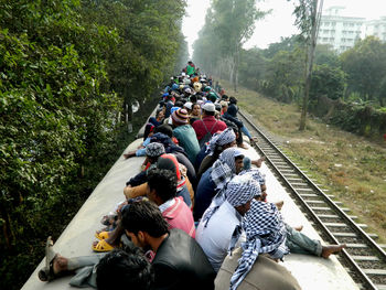 People traveling on rooftop of train