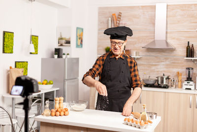 Portrait of woman standing in kitchen