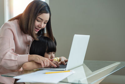 Young woman using laptop at table