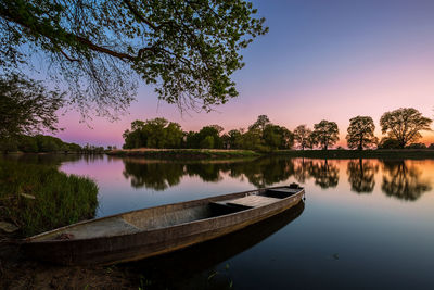 Scenic view of lake against sky at sunset