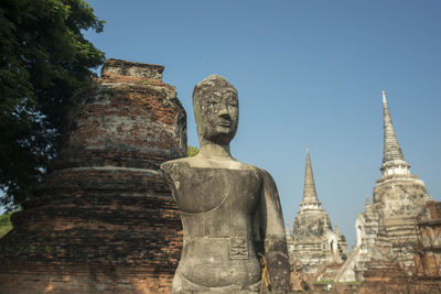 Old ruins at temple against clear blue sky