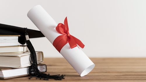 Close-up of open book on table against white background