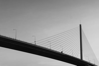 Low angle view of suspension bridge against sky