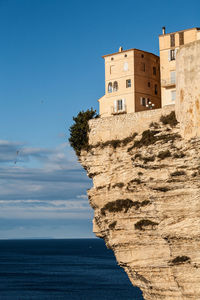 Building by sea against sky