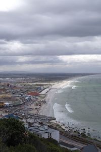 High angle view of sea and buildings against sky