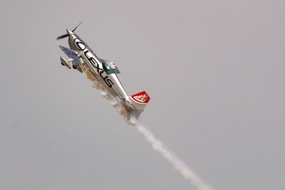 Low angle view of airplane flying against sky