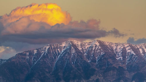 Scenic view of snowcapped mountains against sky during sunset